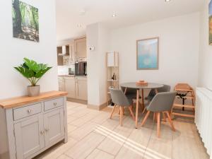 a kitchen and dining room with a table and chairs at 4 Lynton Cottages in Hull