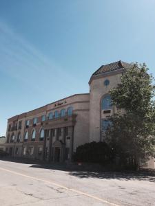 a large building with a tree in front of it at The Bridgeport Inn in Fort McMurray