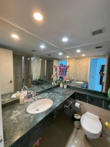 a bathroom with a sink and a toilet and a mirror at Sea Breeze Studios in Netanya