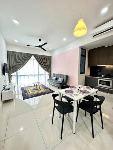 a kitchen with a table and chairs in a room at A1601 Grand Medini 2BR 100mbps Netflix By STAY in Nusajaya