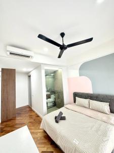 a bedroom with a bed with a ceiling fan at A1601 Grand Medini 2BR 100mbps Netflix By STAY in Nusajaya