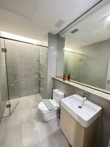 a bathroom with a toilet and a sink and a shower at A1601 Grand Medini 2BR 100mbps Netflix By STAY in Nusajaya