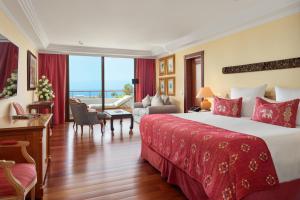 a hotel room with a bed and a living room at Hotel Botanico y Oriental Spa Garden in Puerto de la Cruz