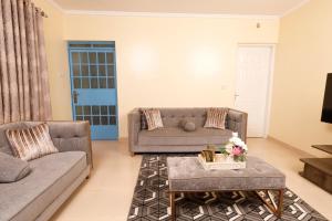 a living room with a couch and a table at Cossy homes in Nakuru