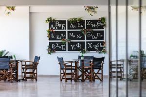 a dining room with tables and chairs and a chalkboard at Lines Concept Accommodation in Rethymno Town