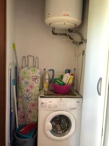 a laundry room with a washing machine and a light at Cozy Apartment in Žabljak