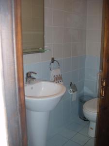 a bathroom with a sink and a toilet at Vrakas House in Tochni +50 photos