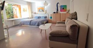 a living room with a couch and a bed at Wohlfühl & Wellness Oase in Neustadt an der Weinstraße