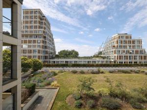 a view of two tall buildings and a garden at Pass the Keys Stylish comfortable apartment in central Kingston in Kingston upon Thames