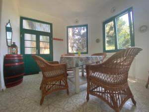 a dining room with a table and four chairs at Villa Délibáb in Badacsonytomaj