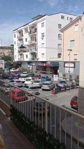 a parking lot with cars parked in front of a building at Vela Latina in Soverato Marina