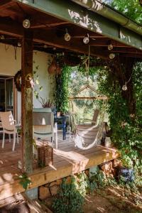 a porch with a hammock on a wooden deck at Cottage house Lublin in Lublin