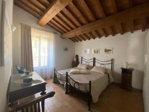 a bedroom with a bed and a table and a window at Villa Le Ripe in Gambassi Terme +70 photos