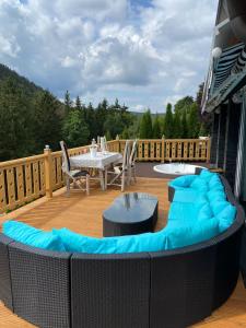 a patio with a table and chairs on a deck at VIP Haus Winterberg in Winterberg