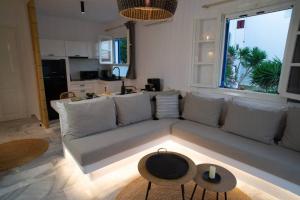 a living room with a couch and a table at TINION Fos in Tinos
