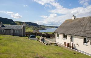 a house on a hill with a view of the ocean at Tulm Bay in Kilmaluag