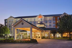 an exterior view of a hotel at night at Hilton Garden Inn Houston/Bush Intercontinental Airport in Houston