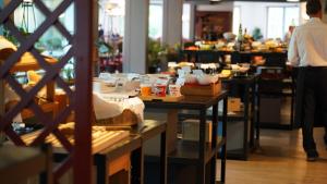 a store with tables with food on them at Havila Hotel Geiranger in Geiranger