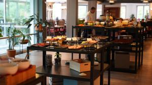 a buffet of food on tables in a restaurant at Havila Hotel Geiranger in Geiranger