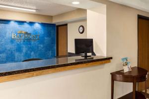 a hotel room with a reception desk with a tv at Baymont by Wyndham Cedar Rapids in Cedar Rapids