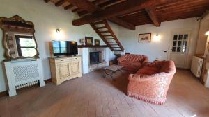 un salon avec deux canapés et une télévision dans l'établissement La Bandita Cottage, à San Venanzo
