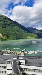 a view of a body of water with boats at Havila Hotel Geiranger in Geiranger