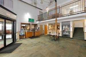 a store lobby with a table and chairs and stairs at Quality Inn in Havre