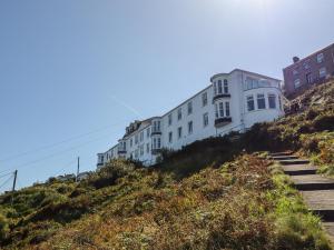 a white building on top of a hill at Starfish in Penzance
