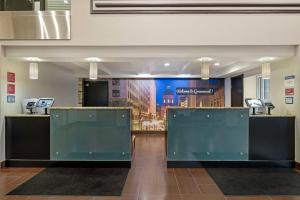 a lobby with two reception desks and a wall at Best Western Plus Greenwood Indy South Inn in Greenwood