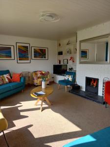 a living room with a couch and a fireplace at Beech House in Fort William