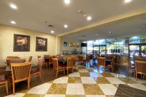 a restaurant with tables and chairs and a bar at Wyndham Garden Newark Fremont Silicon Valley in Newark