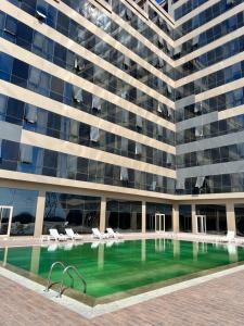 a large building with a swimming pool in front of it at My House N5 Suites Hotel in Esenyurt