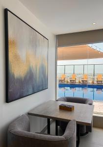 a dining room with a table and chairs at Boulevard Hotel Oman in Seeb