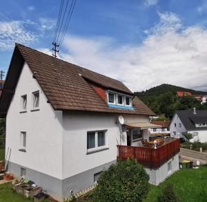 a white house with a brown roof at 3 Zimmer-Apartment mit Terrasse in Gernsbach