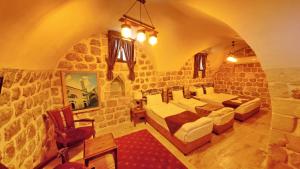 a large room with a stone wall at ULUBEY KONAĞI in Mardin