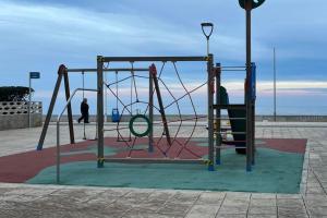 a playground with a swing on the beach at Espectacular ático en Gandia, a 2 minutos de la playa in Bellreguart