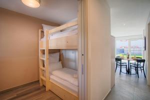 a bedroom with bunk beds in a room with a table at Apartment Lavendel in Naturno