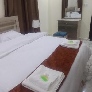 a hotel room with two beds with towels on them at Dream house hotel jerash in Jerash