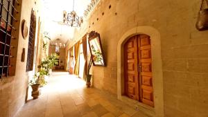 a hallway of a building with a wooden door at ULUBEY KONAĞI in Mardin