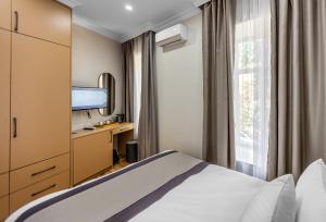 a hotel room with a bed and a window at Hillside City Center Hotel in Baku