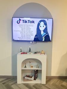 a sign for a tik tok toy on a wall at NK hostel 31 in Ban Bang Phang +11 photos