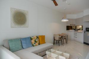 a living room with a couch and a table at Cassia Residences 1 in Bang Tao Beach
