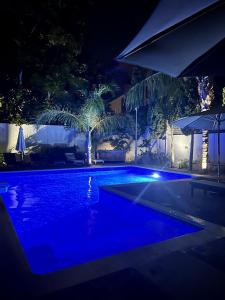 a swimming pool at night with blue lights at Villa 56 Luxury apartments in Rhodes Town