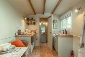 a small kitchen with a sink and a counter at Great Ashley Farm Holiday Cottage & Shepherds Huts in Bradford on Avon