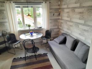 a living room with a couch and a table at Nice holiday home in cozy Billdal in Billdal