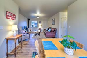 a living room with a table and a couch at Anacortes Condo - Walk to Town, Marina, and Bay! in Anacortes +17 photos