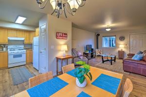 a dining room and living room with a table and chairs at Anacortes Condo - Walk to Town, Marina, and Bay! in Anacortes