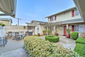 a house with a patio with a table and chairs at Anacortes Condo - Walk to Town, Marina, and Bay! in Anacortes