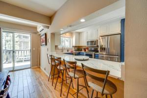 a kitchen with a counter with chairs and a table at Incline Village Retreat Near Skiing and Beaches in Incline Village