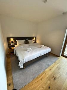 a bedroom with a large white bed in a room at Luxury Mountain Hotel Apartment in Andermatt